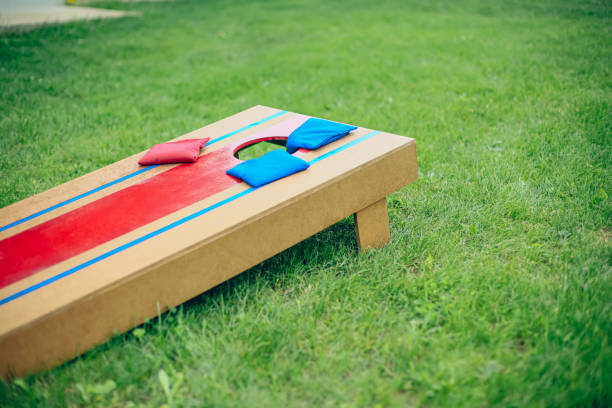 istock Blue and red beanbags sitting on blue cornhole board platform 1700812901