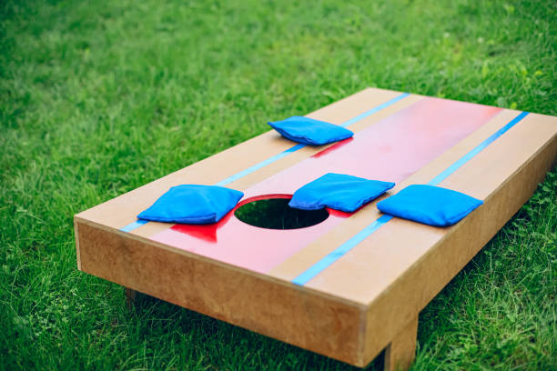 istock Homemade corn hole board game in backyard 1700814002