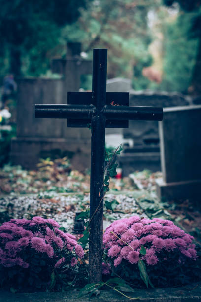 istock All Saints day, cross and flowers 1700818516