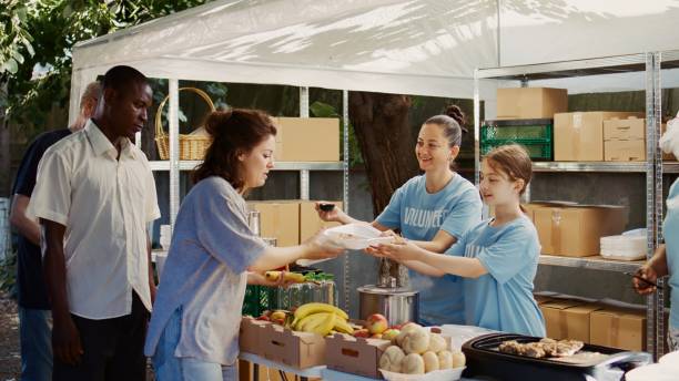 istock Volunteers Helping The Hungry With Care 1700827358