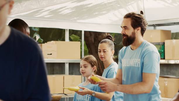 istock Friendly Volunteers At Food Drive Event 1700828462