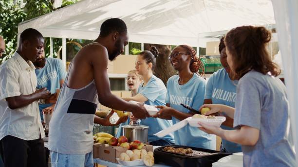 istock Volunteers Share Food To Less Fortunate 1700831760