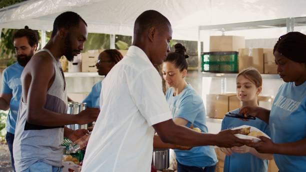 istock Charity Workers Serving Free Food 1700837562