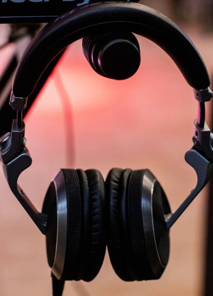 istock Pair of headphones suspended from a handle on a rack 1700875702