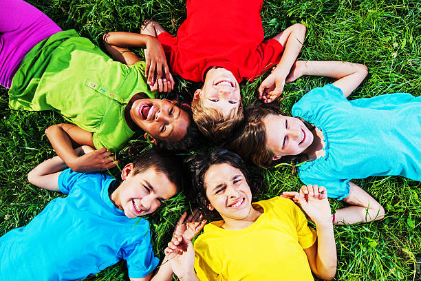 istock Cheerful kids lying in the grass. 170088851