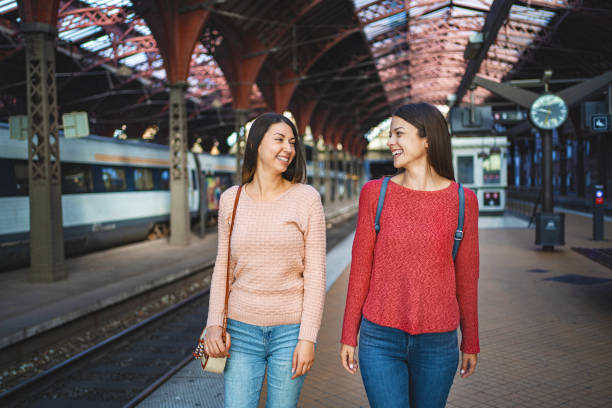 istock Two female friends at the train station 1700889179