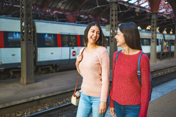 istock Two female friends at the train station 1700889242
