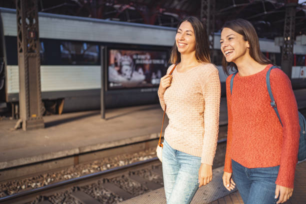 istock Two female friends at the train station 1700889759