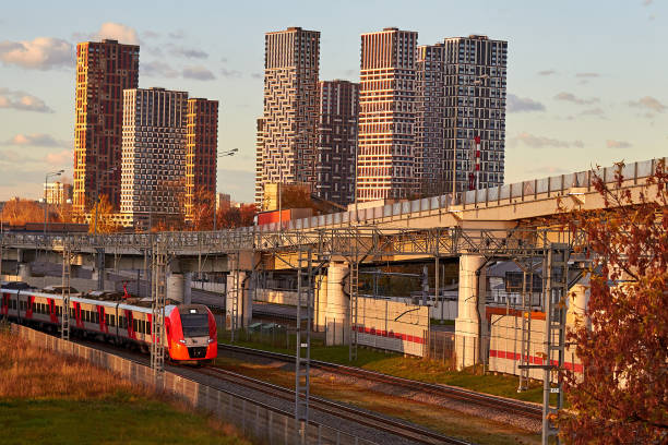 istock Modern high-rise buildings and a high-speed train at sunset 1700894174