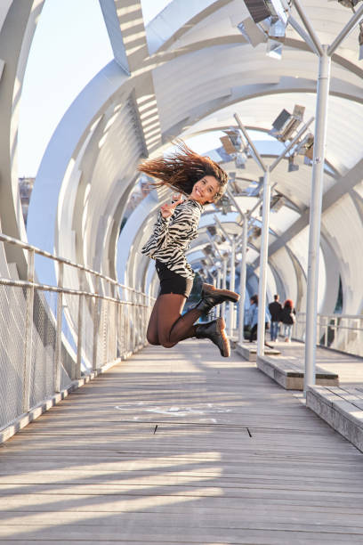 Young doing cartwheel on the Pont d'Iena bridge in front of the iconic Eiffel Tower in Paris. Sunny summer day.Shot with Canon R5