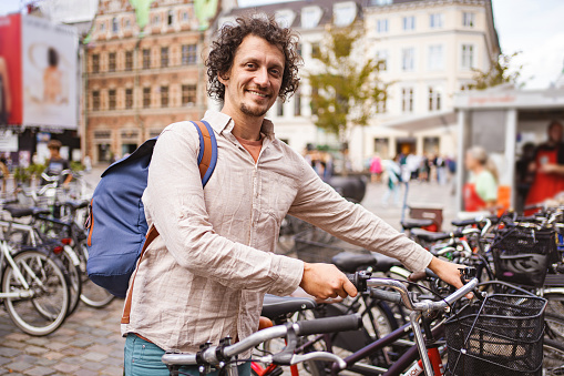 Male tourist renting a bike in the city