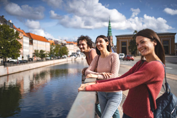 istock Three happy tourists standing by the Nyhavn canal 1700897007