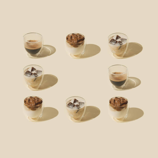 Neatly arranged different types of coffee drinks on pastel background with copy space. Minimal coffee concept. Coffee aesthetic.