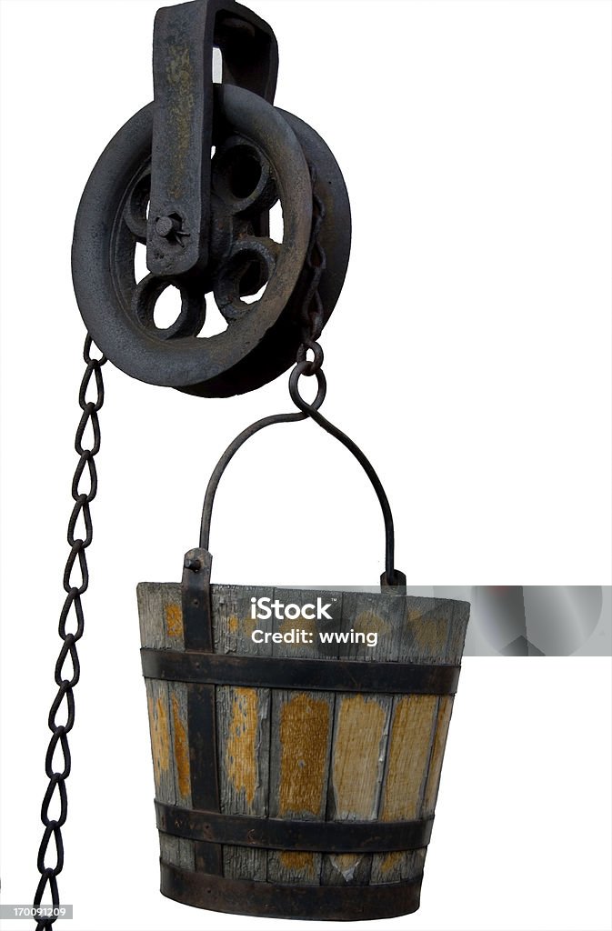 Well Bucket and Pulley A antique well bucket and pulley isolated with clipping path. Pulley Stock Photo