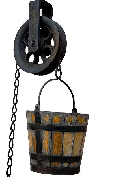 A antique well bucket and pulley isolated with clipping path.