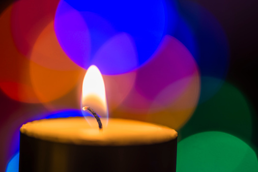 Single Candle with different light background.