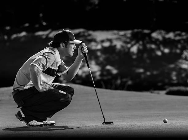 Golfer Putting A man takes aim for his putt.http://blog.michaelsvoboda.com/GolfBanner.jpg game resort pictures stock pictures, royalty-free photos & images