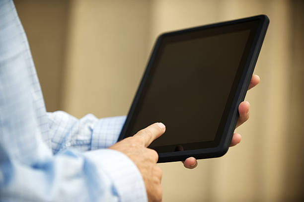 istock Businessman Touches Touchscreen Tablet Close-Up 170093350