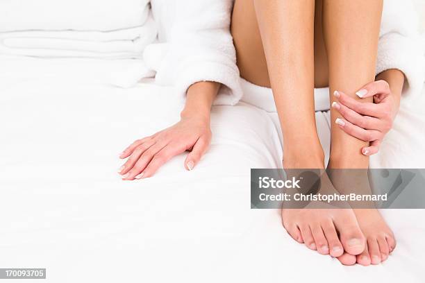 Woman Wearing Robe Sitting On Bed Stock Photo - Download Image Now - Pedicure, Manicure, Women