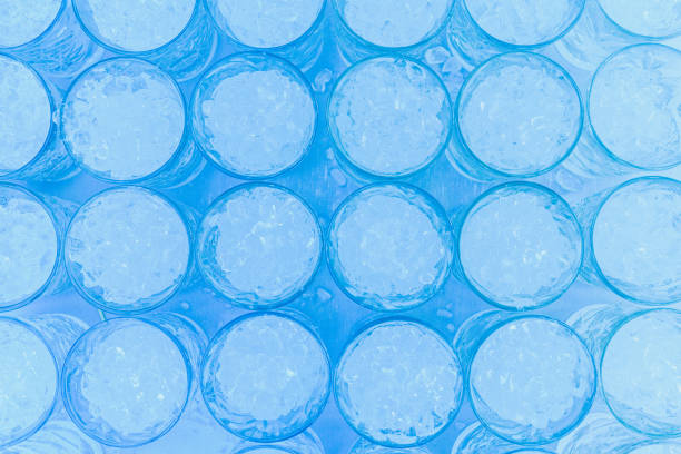 istock Pattern of glasses with ice ready to prepare a cocktail with refreshing background. 1700941736