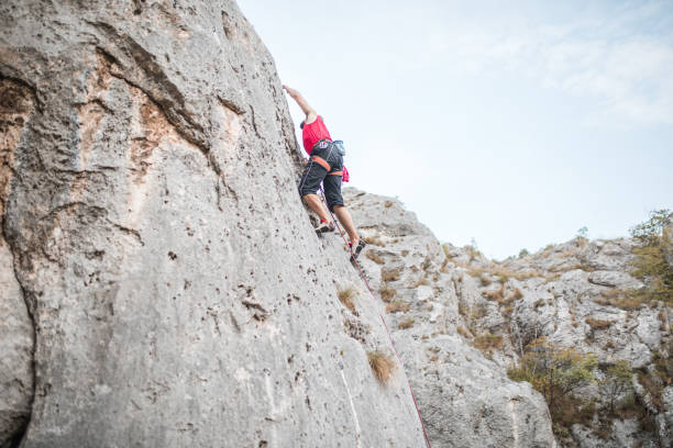 istock A focused male climber climbs a mountain on extreme terrain 1700942268