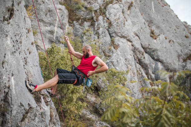 istock A focused male climber overcomes extremely steep terrain by climbing a mountain and using a climbing rope 1700943936