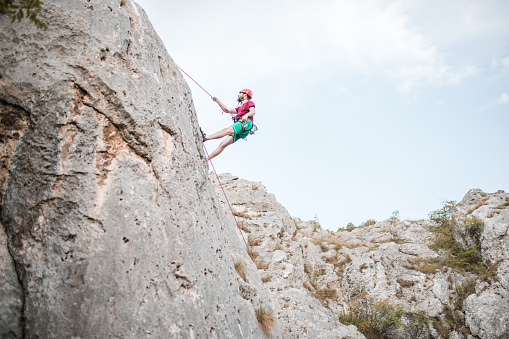 Outdoor climbing sport activity concept : Man climber on artificial climbing wall