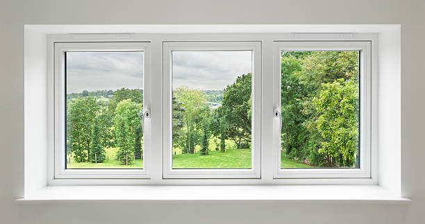 white windows with garden view a set of three windows in a white frame surrounded by a light grey wall with views over a lovely countryside garden. with mature trees. window latch stock pictures, royalty-free photos & images