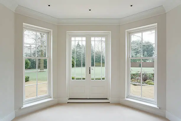 Photo of white bay windows and French doors