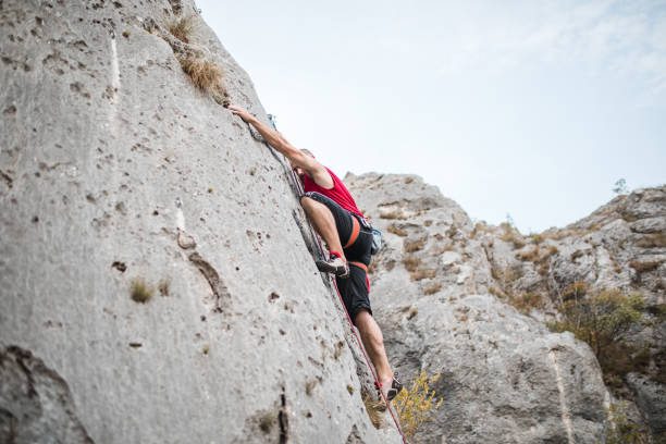 istock A focused man climbs a mountain using special climbing equipment 1700946727