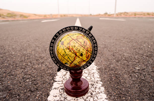 istock Globe Earth on an Asphalt Street 1700947924