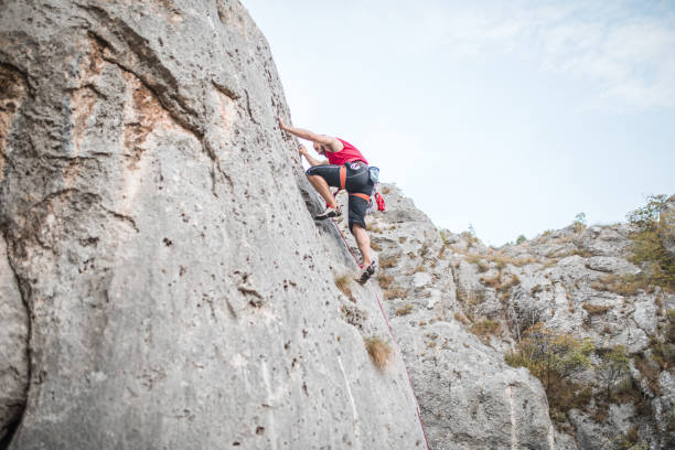 istock A man climbs a mountain using special climbing equipment during the day 1700958789