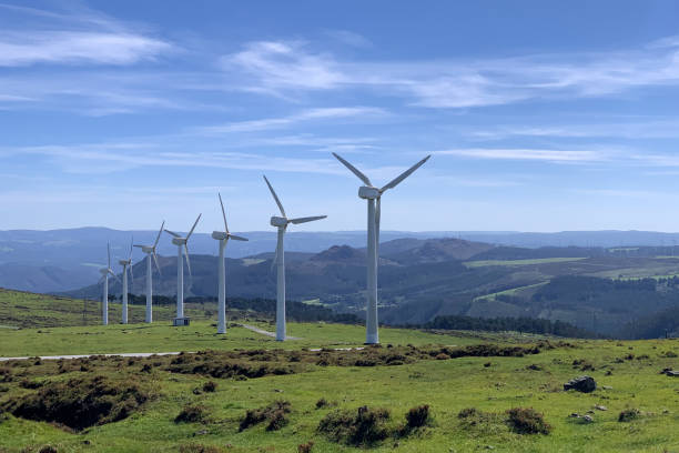 istock wind power plants against a blue sky with clouds on a bright sunny day 1700960100