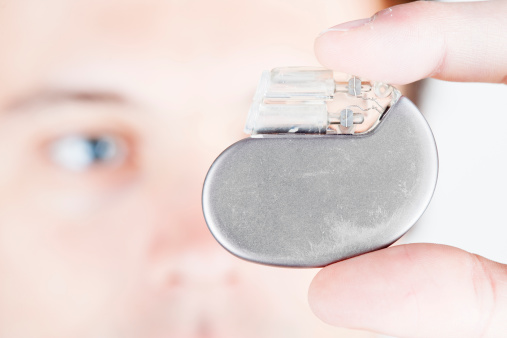 A male person, checking a cardiac pacemaker. XXL size image.