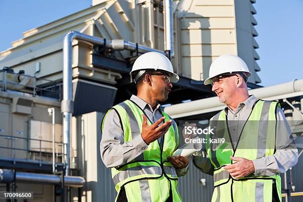 Engineers Talking Near Power Generator Stock Photo - Download Image Now - Power Station, Occupation, People