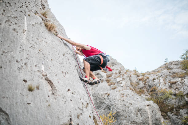 istock A strong man climbs a mountain using special climbing equipment 1700965317