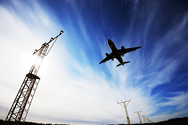 istock Airplane landing against dramatic sky and sun 170096653
