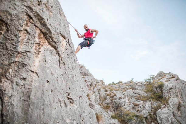 istock A strong man overcomes extremely steep terrain by climbing a mountain and using a climbing rope 1700966910