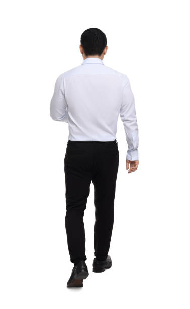 istock Businessman in formal clothes walking on white background, back view 1700976727