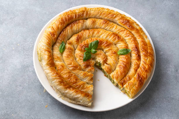 istock Turkish Tepsi Boregi, Round Borek, Tray pastry (Turkish name; rulo borek - ispanakli borek) 1700981169