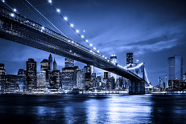 High angle view of Williamsburg Bridge through One World Trade Center's observation point at night. Horizontal composition. Image taken with Nikon D800 and developed from Raw format.