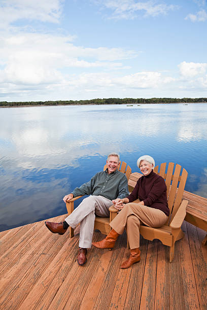 istock Senior couple sitting by water 170098332