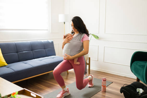 istock Active mother exercising with yoga using a baby carrier 1700991551