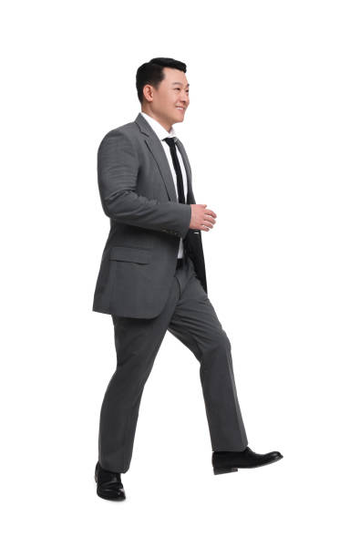 istock Businessman in suit walking on white background 1700993724