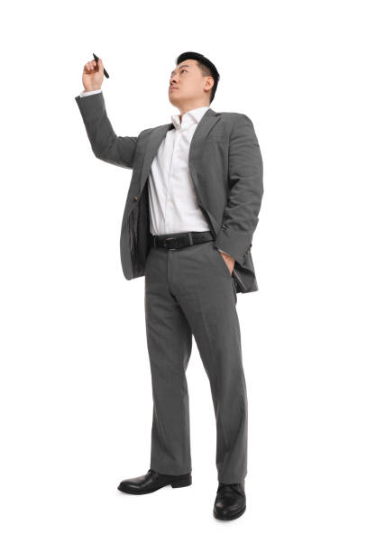 istock Businessman in suit with marker writing on white background, low angle view 1700994283