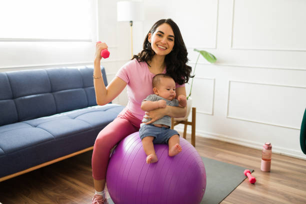 istock Happy mom with her baby working out and smiling 1700994816