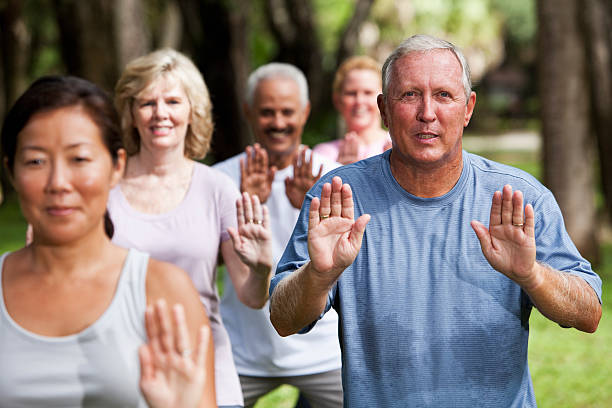 istock Group of adults exercising in park 170099837