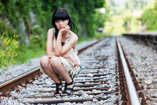 Beautiful girl in fashion clothes on the railway tracks. Shot on event Pletnalypse Bled.