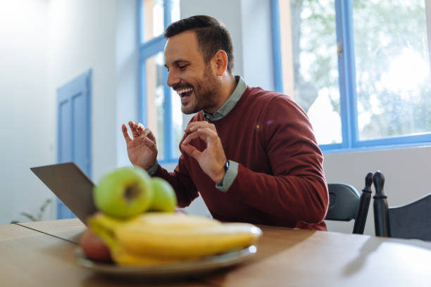 istock Man laughing with his colleagues online 1701002395