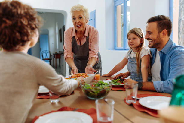 istock Grandma serving lunch to her family 1701002419